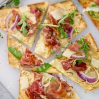 This Crispy Prosciutto Flatbread makes for a great heavy appetizer or light lunch. It tastes even better served with a glass of wine and good company!