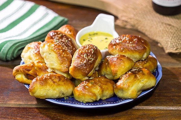 Take the classic pigs in a blanket to a new level...by adding cheese and then wrapping them in pretzel dough! Serve these Pretzel Pigs in a Blanket with a quick and easy honey mustard dipping sauce for extra flavor!