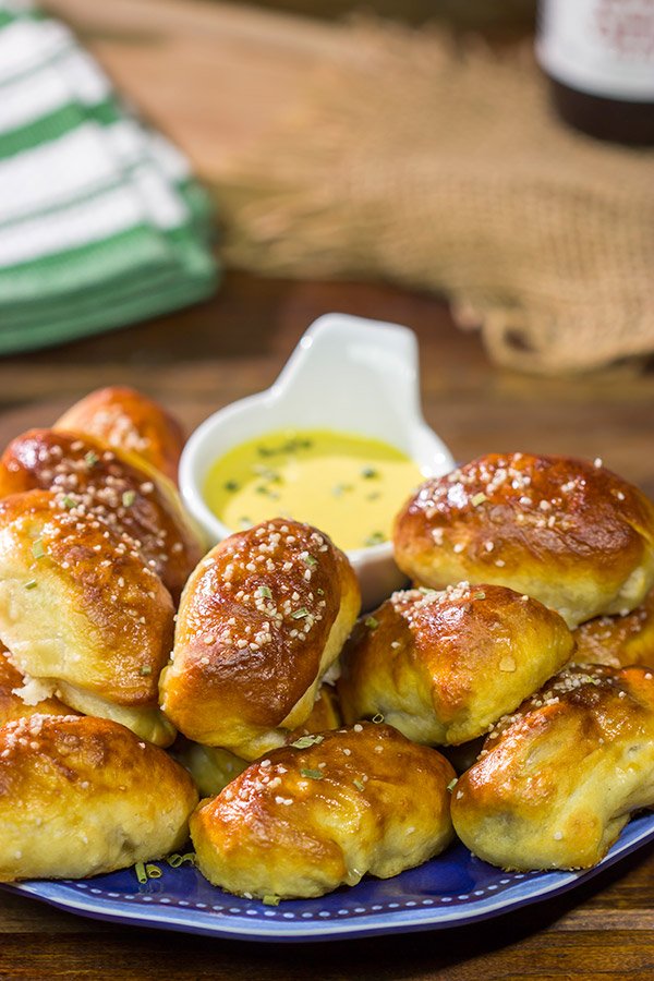 Take the classic pigs in a blanket to a new level...by adding cheese and then wrapping them in pretzel dough! Serve these Pretzel Pigs in a Blanket with a quick and easy honey mustard dipping sauce for extra flavor!