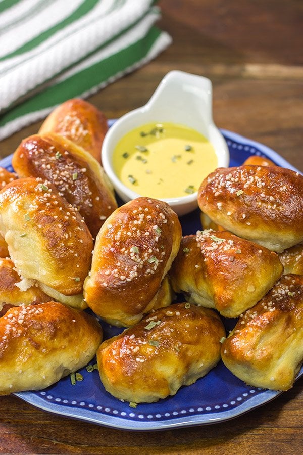 Take the classic pigs in a blanket to a new level...by adding cheese and then wrapping them in pretzel dough! Serve these Pretzel Pigs in a Blanket with a quick and easy honey mustard dipping sauce for extra flavor!
