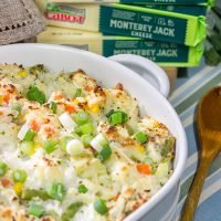 This Cheesy Hash Brown Casserole is a classic Southern recipe - bulked up with veggies and creamy Monterey Jack cheese!  Serve as a side dish or main course!