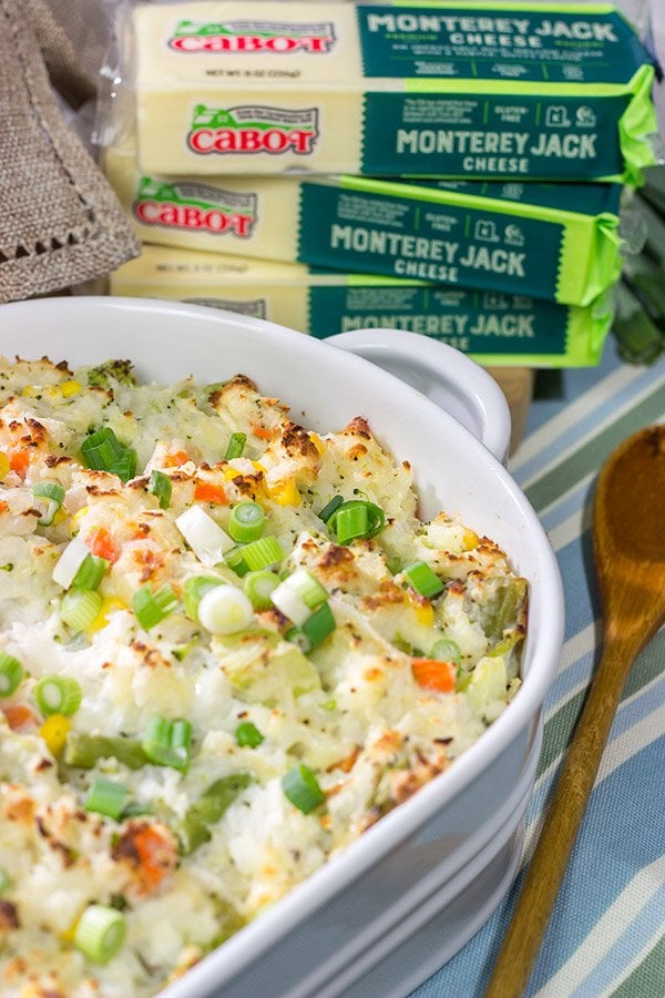 This Cheesy Hash Brown Casserole is a classic Southern recipe - bulked up with veggies and creamy Monterey Jack cheese! Serve as a side dish or main course!