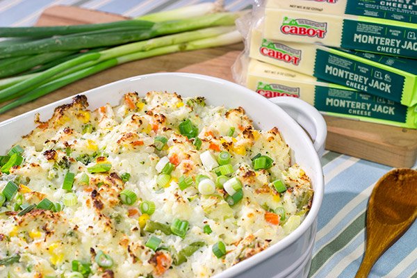 This Cheesy Hash Brown Casserole is a classic Southern recipe - bulked up with veggies and creamy Monterey Jack cheese!  Serve as a side dish or main course!