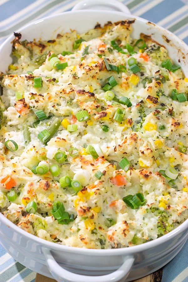 This Cheesy Hash Brown Casserole is a classic Southern recipe - bulked up with veggies and creamy Monterey Jack cheese!  Serve as a side dish or main course!