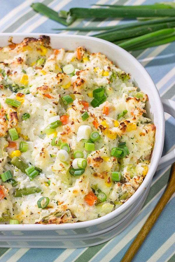 This Cheesy Hash Brown Casserole is a classic Southern recipe - bulked up with veggies and creamy Monterey Jack cheese!  Serve as a side dish or main course!