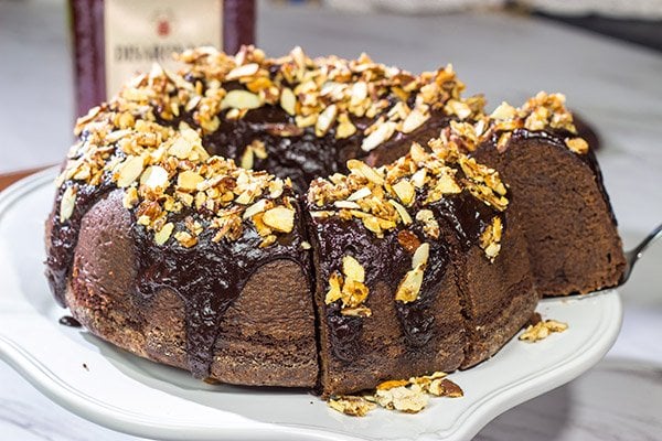 This Chocolate Amaretto Pound Cake is topped with a chocolate amaretto glaze and sprinkled with candied almonds - one bite and you'll be hooked!