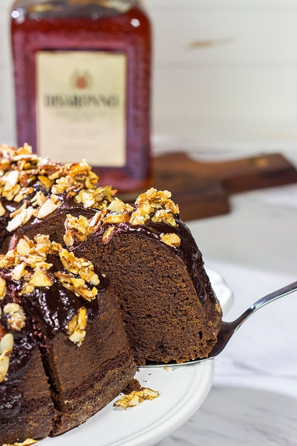 This Chocolate Amaretto Pound Cake is topped with a chocolate amaretto glaze and sprinkled with candied almonds - one bite and you'll be hooked!
