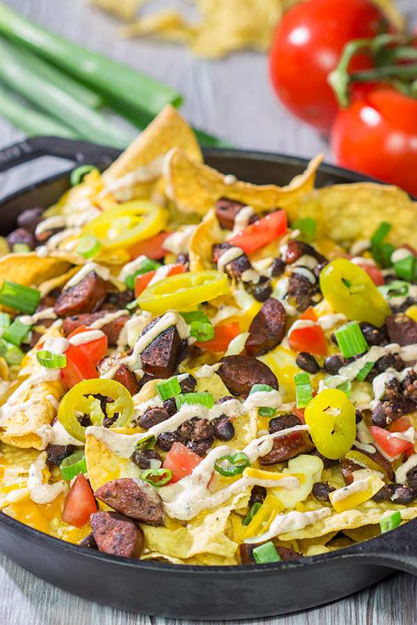 Topped with andouille, Cajun black beans and 2 types of cheese, these Loaded Cajun Nachos make for a delicious appetizer or main course!