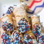 These Red White and Blue Cannoli make for a festive and tasty 4th of July dessert!  (Hint: Using store-bought cannoli shells makes this recipe super easy!)
