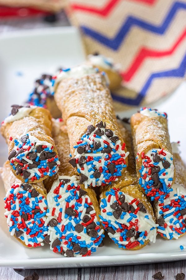 These Red White and Blue Cannoli make for a festive and tasty 4th of July dessert!  (Hint: Using store-bought cannoli shells makes this recipe super easy!)