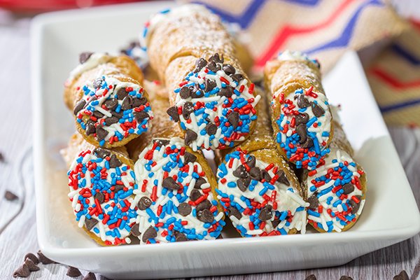 These Red White and Blue Cannoli make for a festive and tasty 4th of July dessert!  (Hint: Using store-bought cannoli shells makes this recipe super easy!)