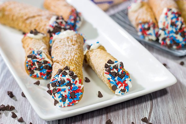 These Red White and Blue Cannoli make for a festive and tasty 4th of July dessert!  (Hint: Using store-bought cannoli shells makes this recipe super easy!)