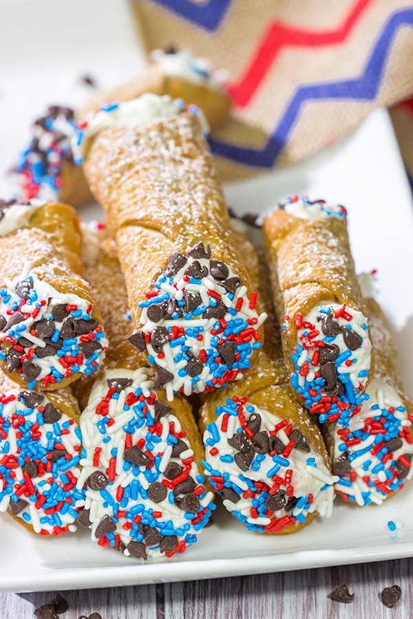 These Red White and Blue Cannoli make for a festive and tasty 4th of July dessert!  (Hint: Using store-bought cannoli shells makes this recipe super easy!)
