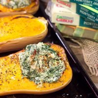 Looking for a fun Autumn recipe? Then put this Spinach Artichoke Stuffed Squash on the menu. Buttery roasted squash combined with creamy spinach artichoke filling makes for a tasty fall meal!