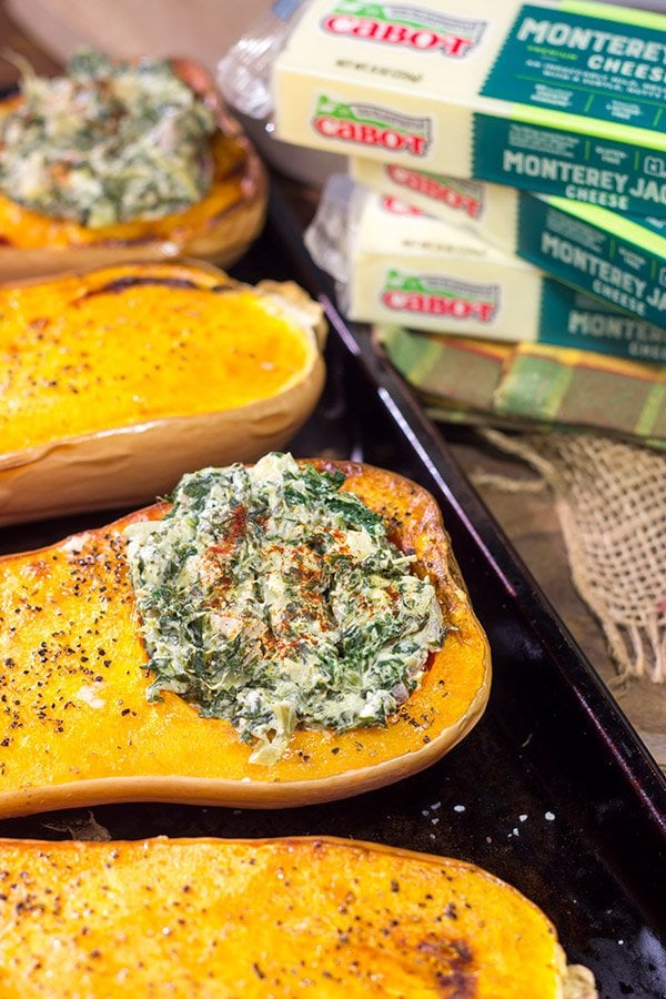 Looking for a fun Autumn recipe? Then put this Spinach Artichoke Stuffed Squash on the menu. Buttery roasted squash combined with creamy spinach artichoke filling makes for a tasty fall meal!
