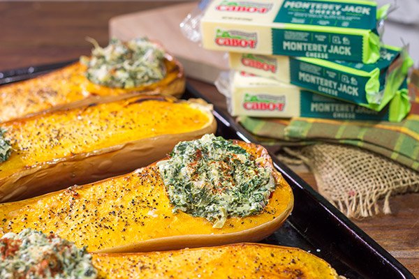 Looking for a fun Autumn recipe?  Then put this Spinach Artichoke Stuffed Squash on the menu.  Buttery roasted squash combined with creamy spinach artichoke filling makes for a tasty fall meal!