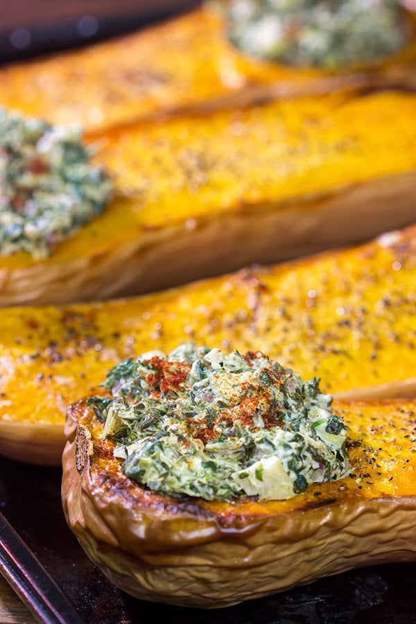 Looking for a fun Autumn recipe?  Then put this Spinach Artichoke Stuffed Squash on the menu.  Buttery roasted squash combined with creamy spinach artichoke filling makes for a tasty fall meal!