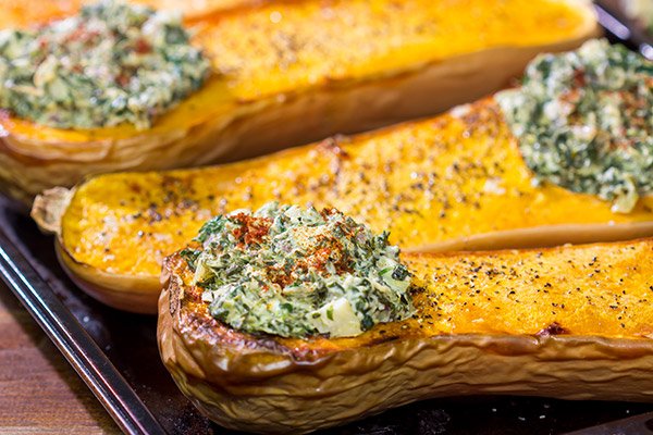 Looking for a fun Autumn recipe?  Then put this Spinach Artichoke Stuffed Squash on the menu.  Buttery roasted squash combined with creamy spinach artichoke filling makes for a tasty fall meal!
