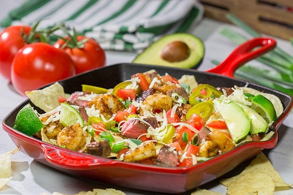 Put a comfort food spin on a classic restaurant favorite.  These Surf and Turf Nachos are topped with juicy steak and flavorful shrimp - whip up a batch for dinner this weekend!