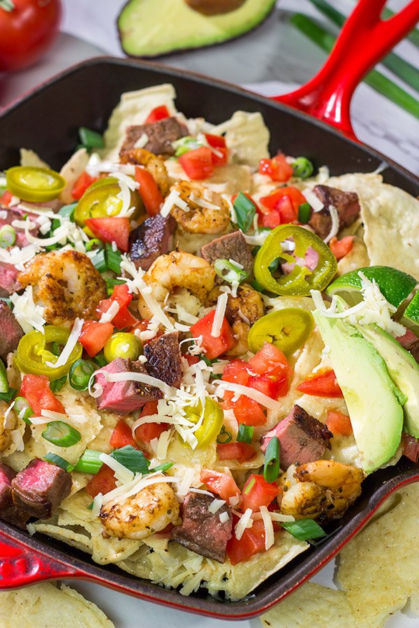 Put a comfort food spin on a classic restaurant favorite.  These Surf and Turf Nachos are topped with juicy steak and flavorful shrimp - whip up a batch for dinner this weekend!