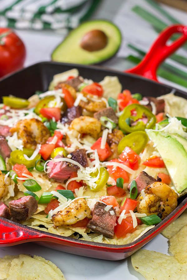 Put a comfort food spin on a classic restaurant favorite.  These Surf and Turf Nachos are topped with juicy steak and flavorful shrimp - whip up a batch for dinner this weekend!