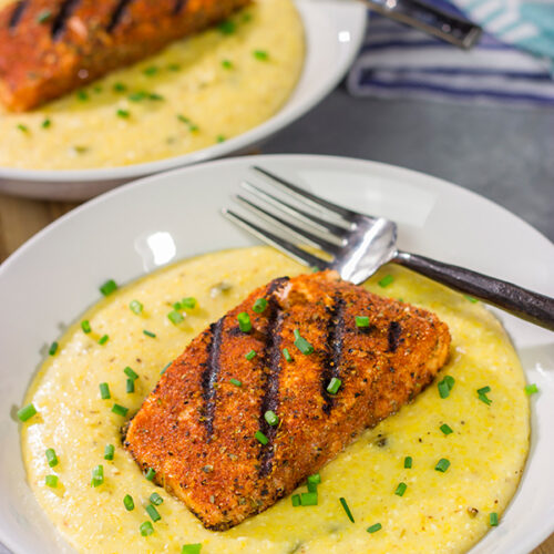 Topped with a flavor-packed piece of Cajun Grilled Salmon, these Cheesy Jalapeno Grits are delicious!  These ain't grandma's grits!