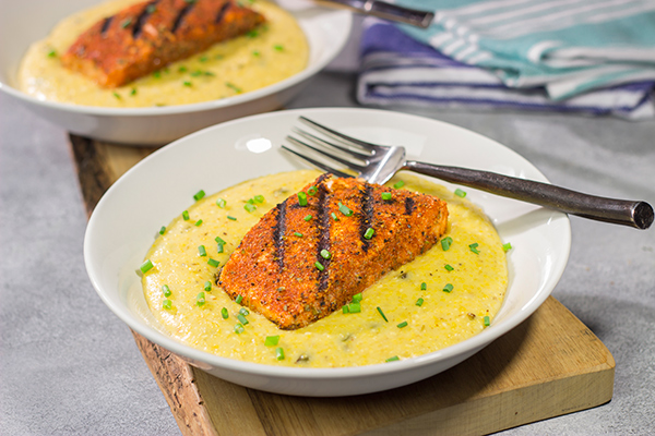 Topped with a flavor-packed piece of Cajun Grilled Salmon, these Cheesy Jalapeno Grits are delicious!  These ain't grandma's grits!