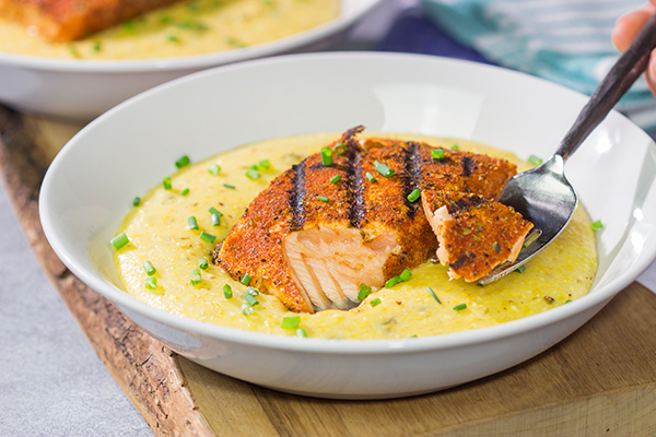 Topped with a flavor-packed piece of Cajun Grilled Salmon, these Cheesy Jalapeno Grits are delicious!  These ain't grandma's grits!