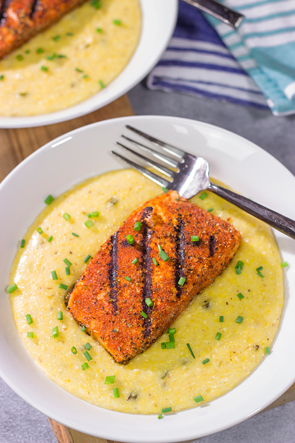 Topped with a flavor-packed piece of Cajun Grilled Salmon, these Cheesy Jalapeno Grits are delicious!  These ain't grandma's grits!