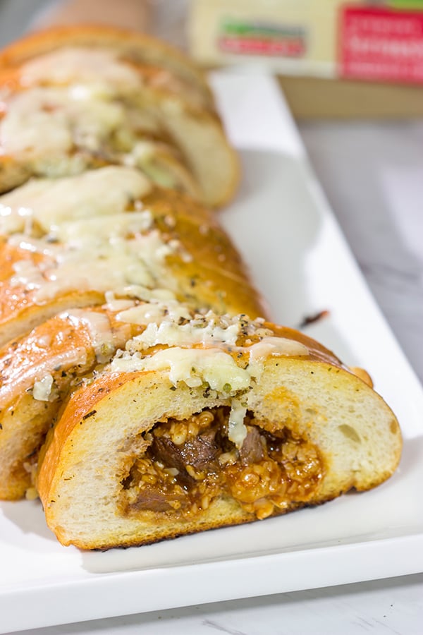 Looking for a fun summer grilling idea?  Fire up the grill and put this Cheesy BBQ Steak Stuffed French Bread on the menu!