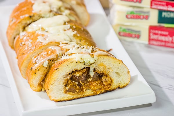 Looking for a fun summer grilling idea? Fire up the grill and put this Cheesy BBQ Steak Stuffed French Bread on the menu!