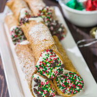 Leave a cannoli for Santa this year! These Christmas Cannoli are a fun (and easy) way to mix up the traditional Christmas cookie plate.