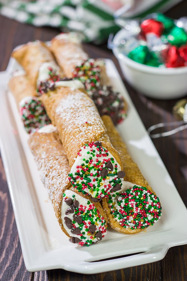 Leave a cannoli for Santa this year!  These Christmas Cannoli are a fun (and easy) way to mix up the traditional Christmas cookie plate.