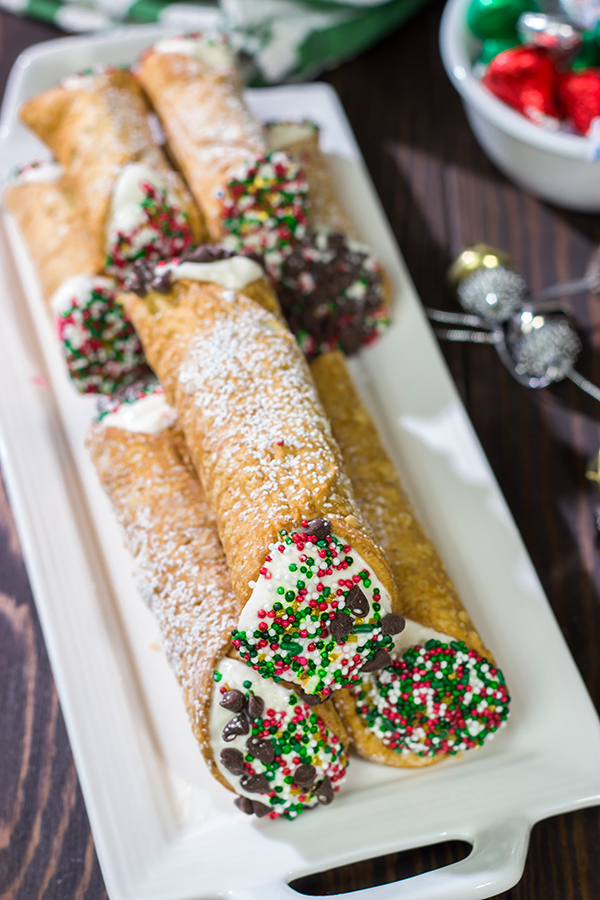 Leave a cannoli for Santa this year!  These Christmas Cannoli are a fun (and easy) way to mix up the traditional Christmas cookie plate.