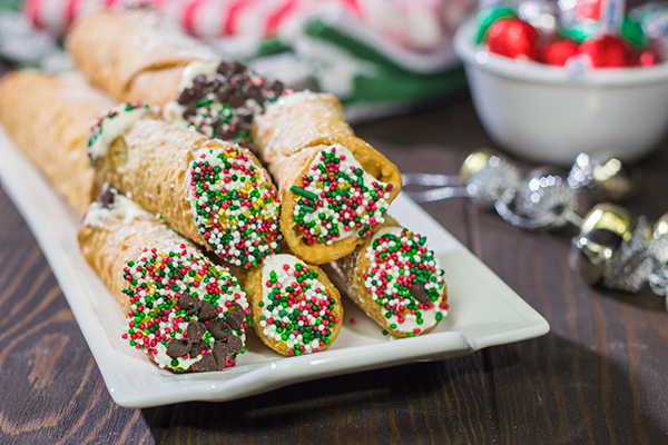 Leave a cannoli for Santa this year!  These Christmas Cannoli are a fun (and easy) way to mix up the traditional Christmas cookie plate.