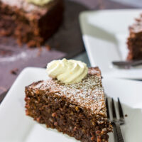 Packed with chocolate and chopped almonds, this Torta Caprese makes for a delicious treat...especially when topped with a dollop of orange-ginger whipped cream!