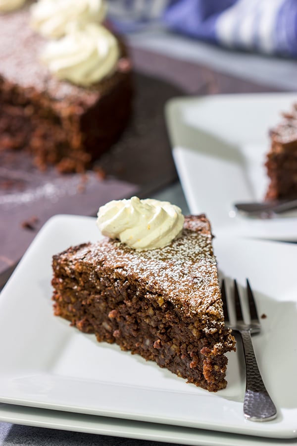 Packed with chocolate and chopped almonds, this Torta Caprese makes for a delicious treat...especially when topped with a dollop of orange-ginger whipped cream!