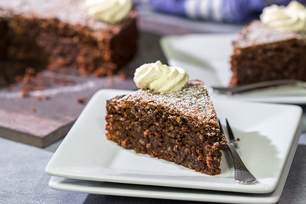 Packed with chocolate and chopped almonds, this Torta Caprese makes for a delicious treat...especially when topped with a dollop of orange-ginger whipped cream!