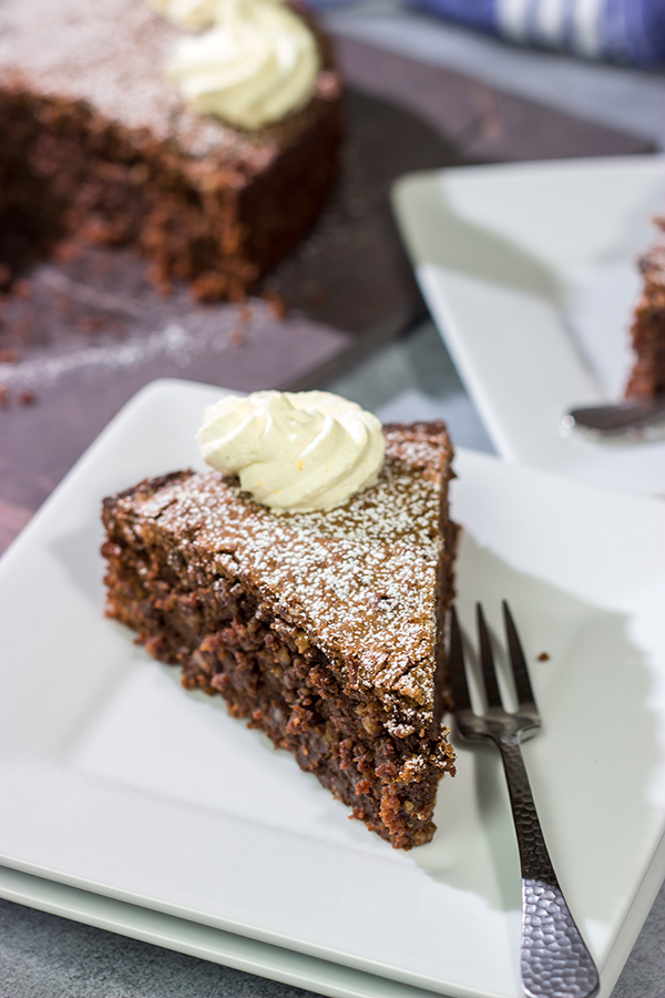Packed with chocolate and chopped almonds, this Torta Caprese makes for a delicious treat...especially when topped with a dollop of orange-ginger whipped cream!