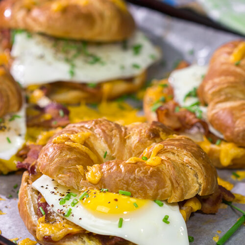 These Bacon and Egg Croissants are an easy and delicious breakfast or brunch recipe! Flaky croissants...melty cheese...crispy bacon...yum!
