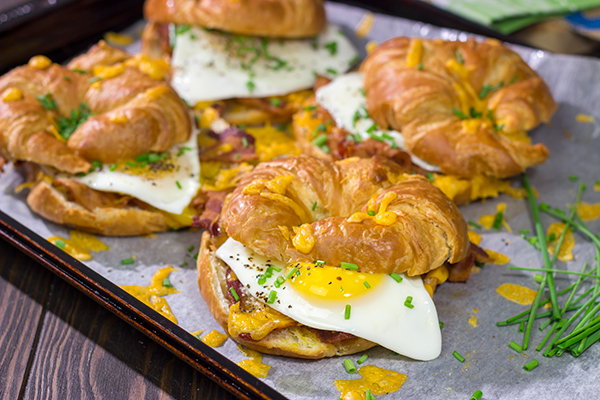 These Bacon and Egg Croissants are an easy and delicious breakfast or brunch recipe! Flaky croissants...melty cheese...crispy bacon...yum!