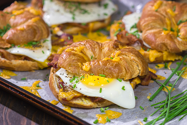 These Bacon and Egg Croissants are an easy and delicious breakfast or brunch recipe! Flaky croissants...melty cheese...crispy bacon...yum!