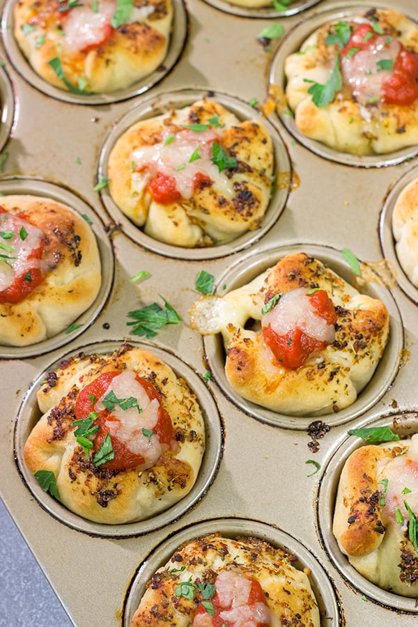 This Meatball Stuffed Garlic Bread features meatballs wrapped in pizza dough and baked in a muffin tin. It's a fun dinner recipe, or it could also work as an appetizer!