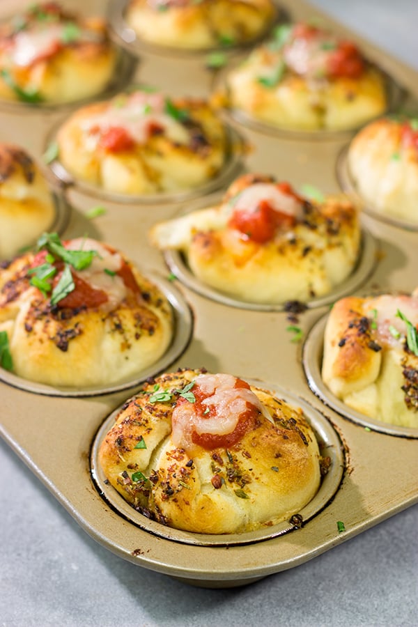 This Meatball Stuffed Garlic Bread features meatballs wrapped in pizza dough and baked in a muffin tin. It's a fun dinner recipe, or it could also work as an appetizer!