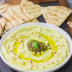 Looking for a fun and tasty summer appetizer? Whip up a batch of Basil Pesto Hummus! This recipe is great to serve when hanging out with friends on the back porch!