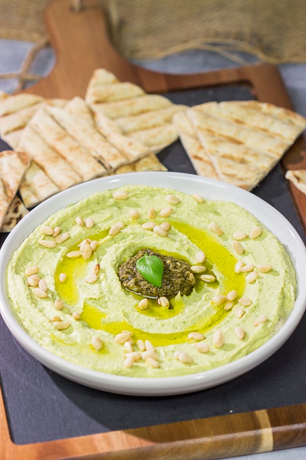 Looking for a fun and tasty summer appetizer? Whip up a batch of Basil Pesto Hummus! This recipe is great to serve when hanging out with friends on the back porch!