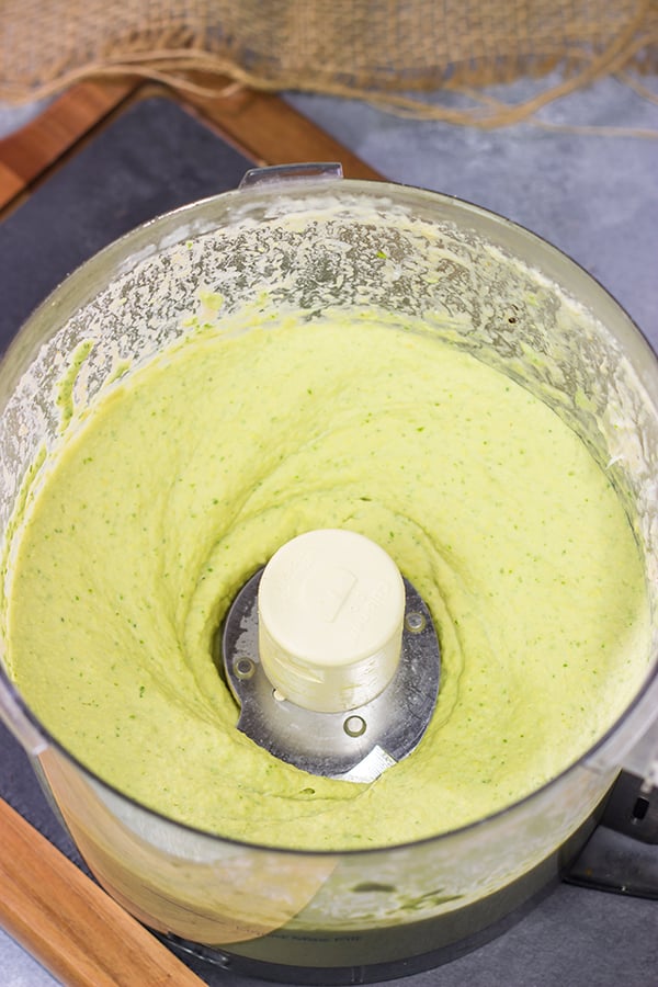 Looking for a fun and tasty summer appetizer? Whip up a batch of Basil Pesto Hummus! This recipe is great to serve when hanging out with friends on the back porch!