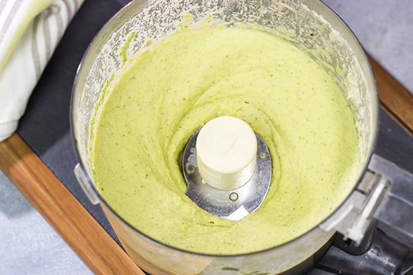 Looking for a fun and tasty summer appetizer? Whip up a batch of Basil Pesto Hummus! This recipe is great to serve when hanging out with friends on the back porch!