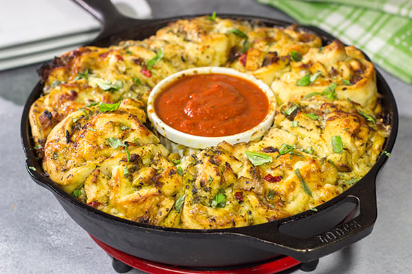 If you're looking for a fun twist on pizza night, then roll up a batch of these Chicken Pesto Pizza Rollups. They're packed with flavor, and they're sure to be a crowd favorite!