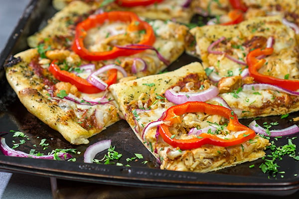 Mix up pizza night with this Tuscan Chicken Pizza! Topped with chicken, red bell peppers and a generous amount of Italian herbs, this pizza makes for a tasty (and easy) meal!